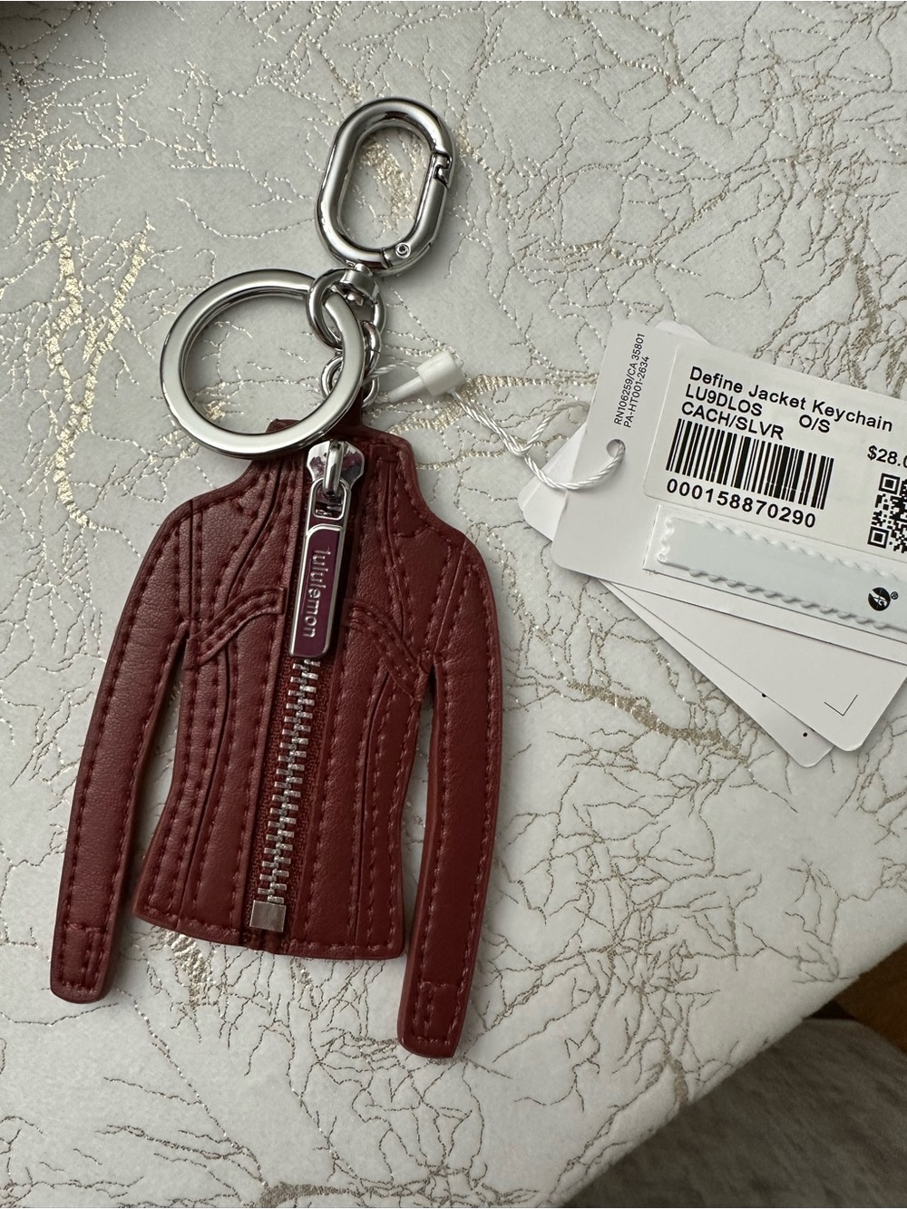 Lululemon Define Jacket Keychain in cranberry charm.
